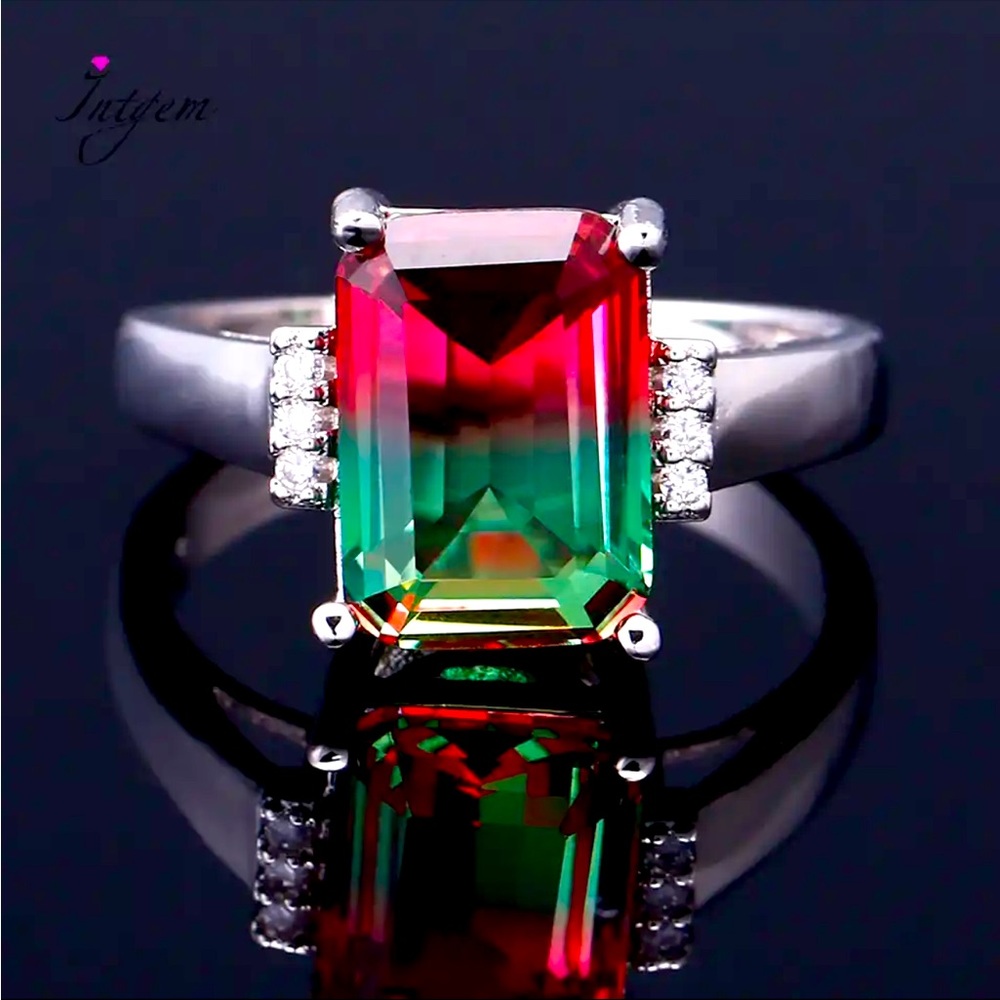Pink and green emerald cut stone with a couple crystals on side of ss ring